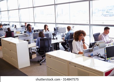 Casually dressed workers in a busy open plan office - Shutterstock ID 314847575