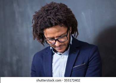 Casually Handsome. Portrait Of Joyful Young Arabic Man Standing Against Grey Background. Afro Hair