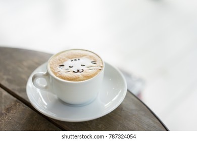 A Cat Face Latte Art Coffee In White Cup On Wooden Table In The Morning.