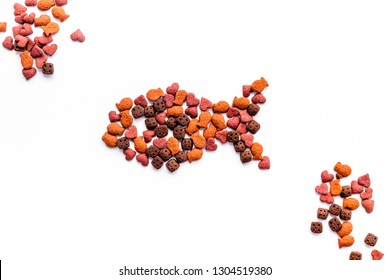 Cat Food. Dry Food In Shape Of Fish On White Backgorund Top View Copy Space