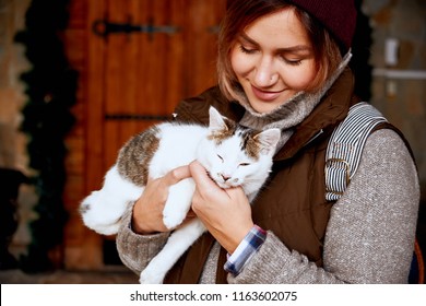 Cat In The Hands Of Girl Volunteer, In Shelter For Homeless Animals. Pets.