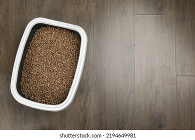 Cat Litter Tray With Filler On Wooden Floor, Top View. Space For Text