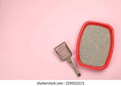 Cat Litter Tray With Filler And Scoop On Pink Background, Flat Lay. Space For Text