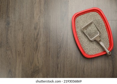 Cat Litter Tray With Filler And Scoop On Wooden Floor, Top View. Space For Text