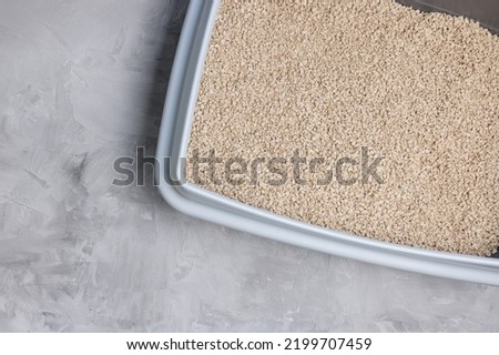 Cat litterbox with natural flushable biodegradable refined active wood pellet as clumping litter. Eco-friendly product for indoor pets. Top view, copy space