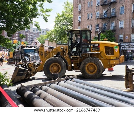 Cat machine at a work site working on the road