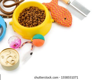 Cat supplies on white background with copy space. Balanced food, different toys, brush and leash. Template for pet shop banner.