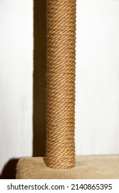 Cat Tree And Furniture, Sisal Rope Cat Scratching Post On Beige Carpet, Vertical Photo With Flash And Deep Shadows