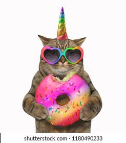 The Cat Unicorn Is Eating A Big Bitten Rainbow Donut White Background.