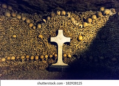 Catacombs of Paris, France. Famous Catacombs (Les catacombes de Paris) are underground ossuaries and tourist attraction. Unusual museum in the old dark dungeon. Scary tunnel with human bones.