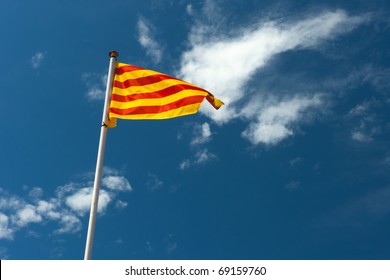 Catalan flag blowing in the wind on blue sky