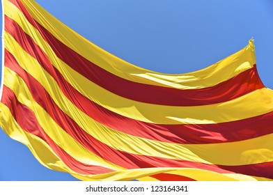 The Catalan national flag on Montjuic in Barcelona. The city is the capital of Catalonia. Catalonia is an autonomous community of Spain with his own flag
