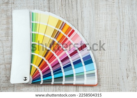 catalog in bright color palette close-up on desk.  Graphic designer chooses colors in sampler