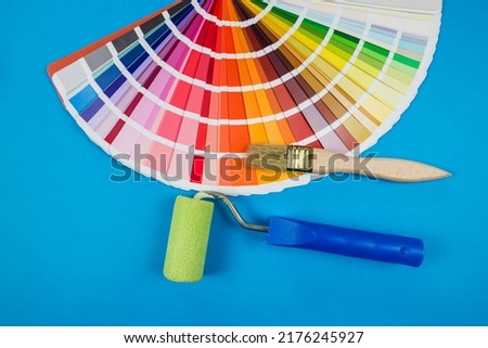 A catalog of paints with a varied color palette and a paint brush. Color selection.