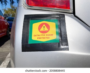 Catalytic Guard Protected sign on vehicle bumper. Catalytic converter theft prevention. - Shutterstock ID 2058808445