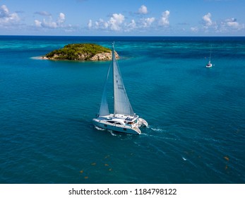 Catamaran in the Antigua ocean by a small island