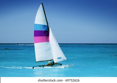 Catamaran In Caribbean Sea On Blue Sky Background