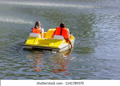 Catamaran floats on the water in a pond
