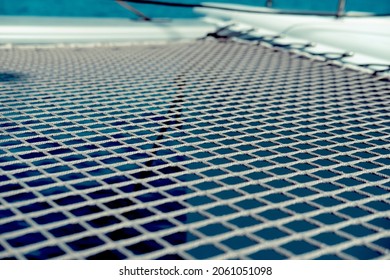 Catamaran Net Of Artificial Fibres On Water Background, Dark Blue, White Ropes, Close Up, Front Deck, Boat Front