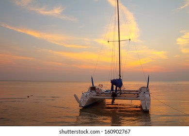 Catamaran On Tropical Beach At Sunset