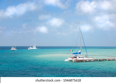 A Catamaran And Other Boat Near The Shore On Isla Mujeres, Mexico.