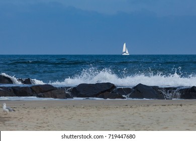 A Catamaran Sailboat Sails Past The Jetty In Deal, New Jersey. Tropical Storm Jose Made For Some Rough Water.