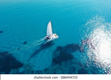 Catamaran sailing on turquoise waters  
