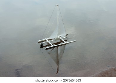 Catamaran Sails Blown By The Wind Reflected In The Water