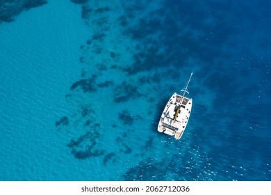 Catamaran yacht near the rocky coast in Turkey. Luxury vacation at sea