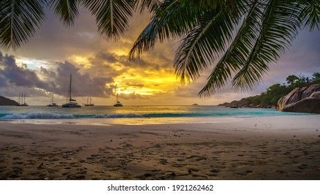 catamarans at sunset at anse lazio on praslin on the seychelles
