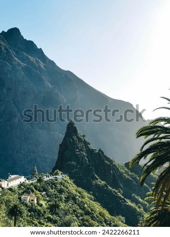 Catana rock near houses in the village against the huge mountain in Masca gorge, Tenerife, Canary islands.