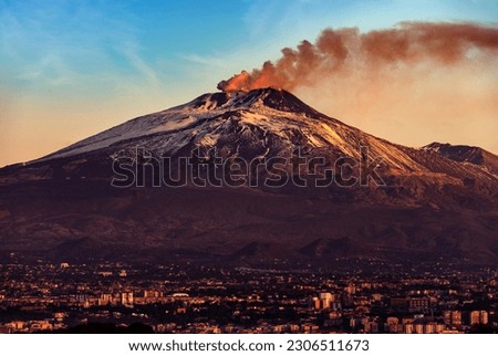 Catania cityscape and the Mount Etna Volcano with smoke at dawn, Sicily island, Italy, Europe