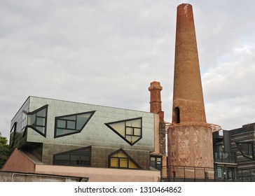 CATANIA, CT/ITALY - DECEMBER 24, 2013: image showing a police station (modern building) and a vintage chimney along Viale Africa.