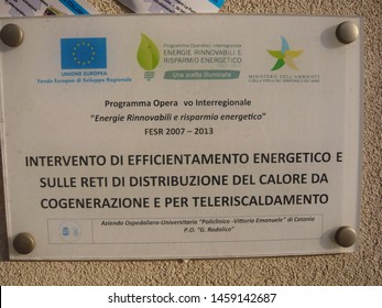 Catania - Italy / July 18, 2019. The Explanatory Plate At The University Hospital Of Catania (Sicily) About The Energy Efficiency Project Of The European Union On Cogeneration And Central Heating.