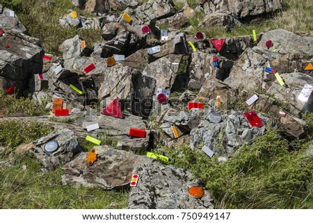 Cataphotes of different shapes and sizes are glued on stones in the Carpathian mountains (Ukraine, Carpathians, Dragobrat)