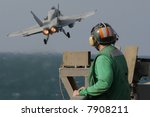 A Catapult Crewman Watches an F/A-18C Hornet Launch From the Nuclear Aircraft Carrier, USS Enterprise