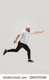 Catch Customer. Portrait Of Cook, Chef Man Wearing Restraunt Uniform Running To Kitchen Isolated On White Background. Cuisine, Profession, Occupation, Funny Meme Emotions Concept. Copyspace For Ad.