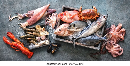 Catch of fresh fish and seafood with ice on store. Top view - Powered by Shutterstock
