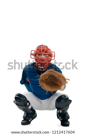 Catcher squatting behind home plate. Young man wearing gear and uniform. Baseball player in action, isolated on white.