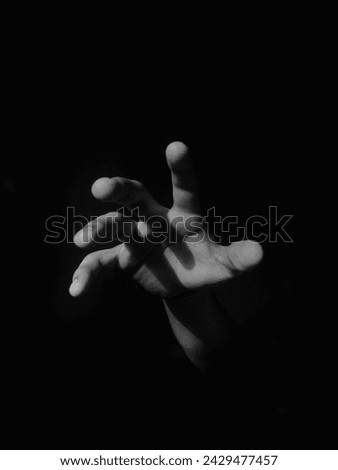 Catching hand from a dark void