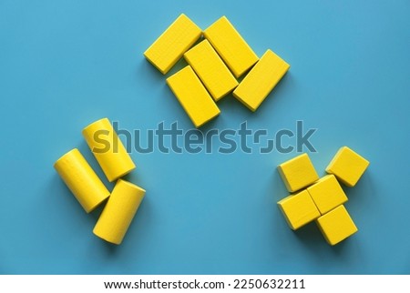 Category concept. Different shape of yellow wooden geometry block rearrange into its category.