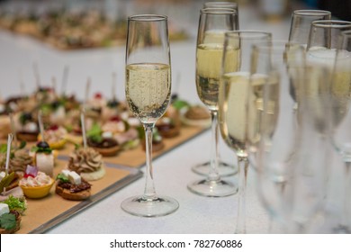 Catering Banquet table with canapes, snacks, festive table, slices, glasses