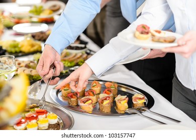 Catering at business company event people choosing buffet food appetizers - Powered by Shutterstock