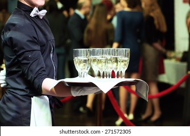 Catering Or Celebration Concept. Waiter Holding A Tray With Glasses Of Vine At Party