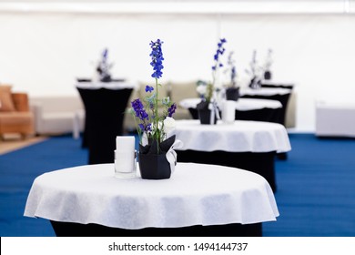 Catering, High Buffet Tables With A Black And White Tablecloth In Lobby, Large Tent With Blue Floor. Concept Banquet, Table Setting For Party, Wedding, Celebration, Concert, Conference