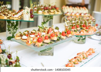 Catering. Off-site food. Buffet table with various canapes, sandwiches, hamburgers and snacks. 