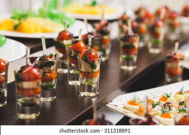 Catering for party. Close up of sandwiches, appetizers and fruit. Christmas, birthday or wedding holiday dinner 