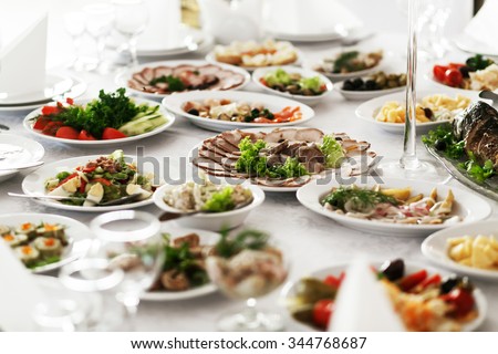 Catering service. Restaurant table with food. Huge amount of food on the table. Plates of food. Dinner time, lunch.