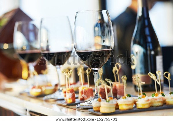catering services background with\
snacks and glasses of wine on bartender counter in\
restaurant