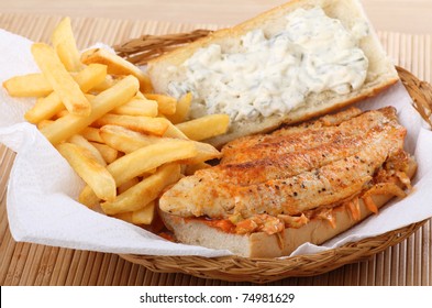 Catfish Fillet Sandwich With French Fries And Coleslaw In A Basket